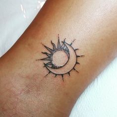 a small sun and moon tattoo on the ankle or foot, done by an artist