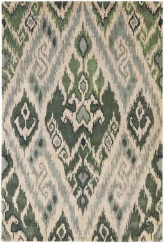 an old rug with green and white designs on it