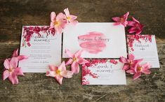 wedding stationery with pink flowers on wooden table