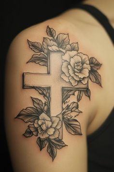 a cross with flowers and leaves on the upper half of the arm, tattoo style