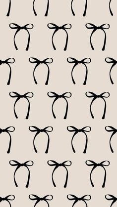 black and white bow tie pattern on a light gray background, seamless to be used for wallpaper or fabric