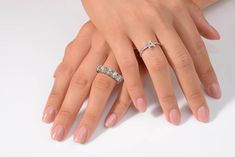 two women's hands with wedding rings on them