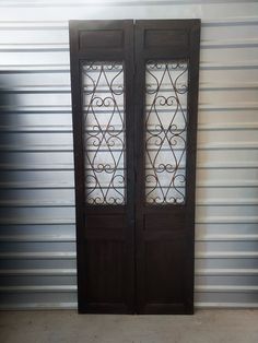 two doors with decorative glass in front of a wall