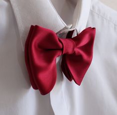 "Oversized Bow Tie in Burgundy Satin Pre-tied and adjustable strap. Bow tie size - Width: 12 cm /4,7\" | Height: 10 cm / 3.93'' The adjustable strap takes it to 21\" in length, making it a great accessory that can be adjusted for comfort and fit or given as a gift if you are unsure of neck size. Perfect for formal or causal use. **bowties are shipped in a small shipping box to keep them from being damaged** Always made by hand and to your special order. Weddings and groups are welcome." Adjustable Red Suit And Tie Accessories For Wedding, Adjustable Red Bow Tie For Wedding, Standard Tie Bow With Ribbon For Wedding, Standard Tie Ribbon Bow For Wedding, Standard Tie Wedding Bow With Ribbon, Satin Bow Ties For Wedding, Classic Red Bow Tie For Wedding, Elegant Red Bow Tie For Wedding, Satin Bow Tie Back Wedding Ties