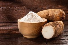 ginger root and powdered sugar in a wooden bowl