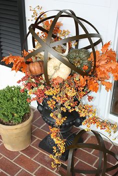 a potted plant sitting on top of a table next to a vase filled with flowers