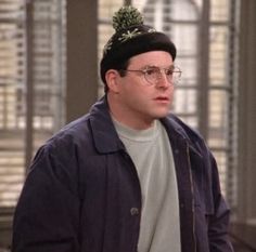 a man wearing glasses and a beanie hat