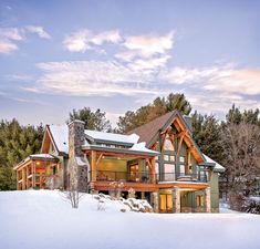 a large house in the middle of a snow covered field