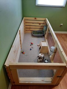 a small dog house made out of pallets and wooden crates with toys in it