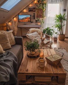 a living room filled with furniture and a flat screen tv on top of a wooden table