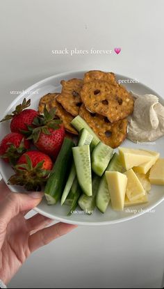 a white plate topped with fruit and crackers