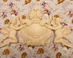 two cherubs on a floral wallpaper with purple and yellow flowers