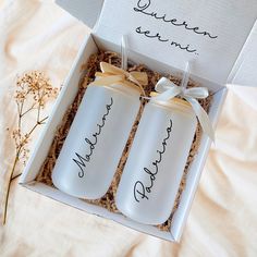 two personalized water bottles in a gift box with the names of their bride and groom