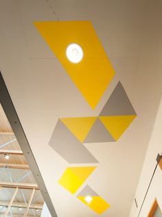 the ceiling is decorated with yellow and grey shapes