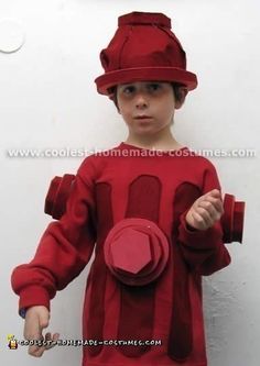 a young boy wearing a red costume and hat