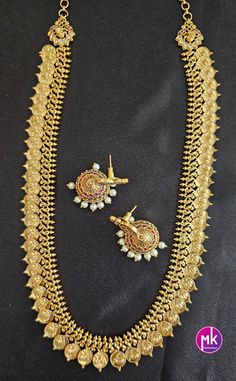 Peacock Kasu Premium Quality Matte gold finish long Haram with matching Jhumka - Bridal Haram - Gold Jewelry Replica - MK Fashionkart Material: Premium Quality Matte gold finish AD stones, pearls Earrings: Matching Jhumka Suitable for Saree/Salwar/party wear dresses Adjustable length    SHIPPING : Ready to ship in 1 business day. This item will be shipped from The United States. Jewelry care instructions : 1. Please wipe the jewelry with a piece of cotton cloth after usage.  2. Store the jewelry in a cool, dry and air tight box or pouch.  3. Make sure the jewelry is away from direct heat and water. 4. Please wipe of any moisture, sweat, soap water after usage. Festive Gold Sets For Navratri, Gold Sets With Pallu For Festivals, Gold Sets With Pallu For Navratri, Elegant Gold Sets For Navratri, Gold Sets With Pallu Detail For Festivals, Gold Traditional Wear With Tilla Embroidery, Gold Tilla Set For Festive Occasions, Festive Gold Set With Pallu, Festive Gold Sets With Tilla Details