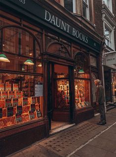 a man standing in front of a book store