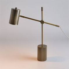 a table lamp that is on top of a small cup with a light attached to it