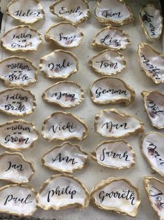 oysters with names on them sitting on a tray