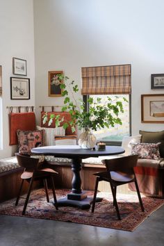 a living room filled with furniture and a potted plant on top of a table