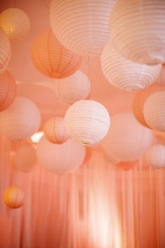 many white paper lanterns hanging from the ceiling