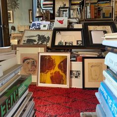 a room filled with lots of books and framed pictures