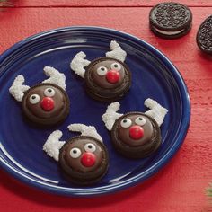 three chocolate reindeer cookies on a blue plate