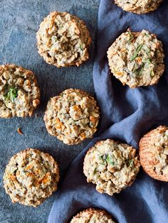 several muffins are sitting on a blue cloth