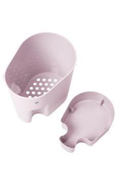 two plastic dishes sitting next to each other on a white surface with holes in the middle