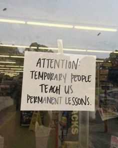 a sign posted in the window of a store telling customers to teach them how to use technology