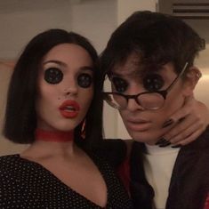 a man and woman are dressed up for halloween with fake eyeballs on their faces