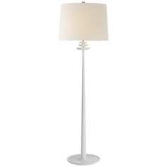 a floor lamp with a white shade on it's base and a light in the middle