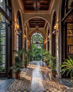 an ornate entry way with potted plants on either side and large windows above it