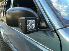 a close up of a car's side view mirror with the lights turned on