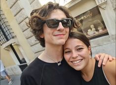 a young man and woman are smiling for the camera