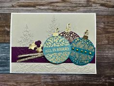 three ornament ornaments on top of a card with the words all is merry