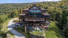 an aerial view of a large house in the mountains