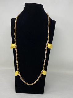 This listing is for 1 piece.At wholesale price!!!This is a Unique African designs majestic piece of jewelry statement long necklace. It is a beautiful and unique accessorize which will make a stunning addition to your costume. This is 100% handmade necklace with 7 mm Natural Wooden Matte Jasper with African Faces Charms made with 18K Matte Gold overlay over brass with anti tarnish. The necklace looks more beautiful in real life. If you need any more information please do not hesitate to contact Gold Hand-strung Agate Necklace, Gold Beaded Necklaces With Gemstone In Temple Jewelry Style, Traditional Gold Beaded Necklaces With Natural Stones, Gold Beaded Necklace With Gemstone In Temple Jewelry Style, Gold Temple Jewelry Beaded Necklace With Gemstone, Gold Hand-strung Spiritual Beaded Necklaces, Gold Gemstone Beads Long Necklace, Gold Spiritual Beaded Necklaces Hand-strung, Gold Agate Beaded Necklace With Natural Stones