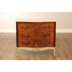 an antique chest of drawers with gold trim