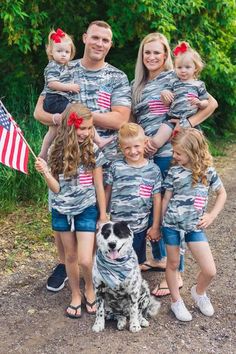 the family is posing for a photo with their dog and american flag t - shirts