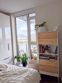 a bed sitting next to a window in a bedroom