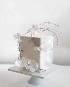 a white cake with flowers and branches on top