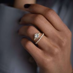 a woman's hand with a ring on her finger and the words stargaze ring