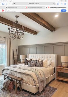 a large bed sitting under a chandelier in a bedroom next to a window