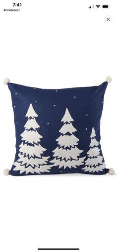 a blue pillow with white trees on it