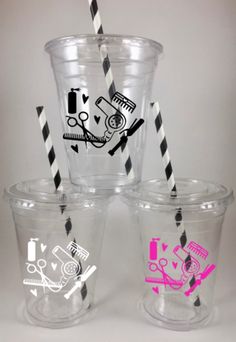 three plastic cups with black and white striped straws