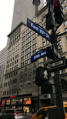 the street signs are clearly visible for everyone to see on this busy city street in new york