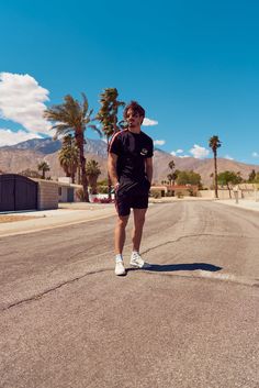 a man walking down the middle of an empty street