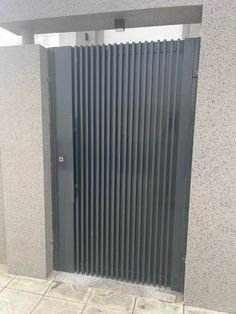 an open door in the side of a building with vertical slats on it's sides