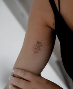 a woman with a small tattoo on her arm